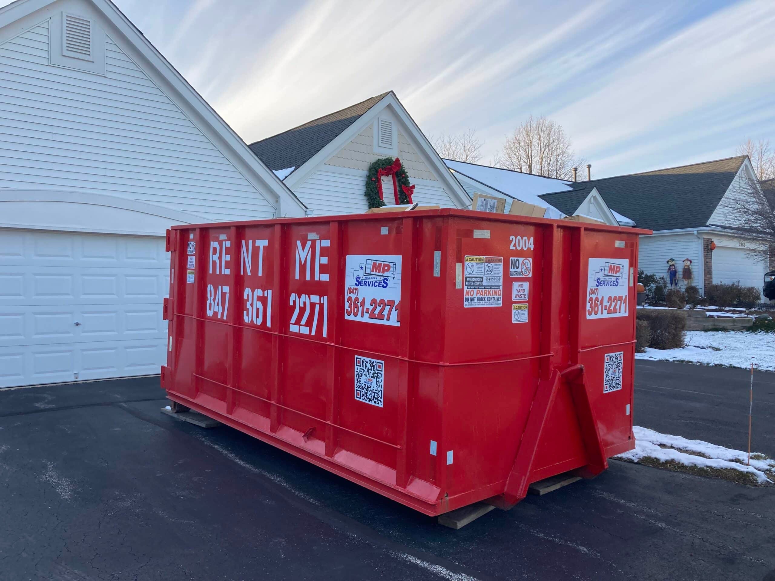 Roll off dumpster on a residential driveway during a home clean out